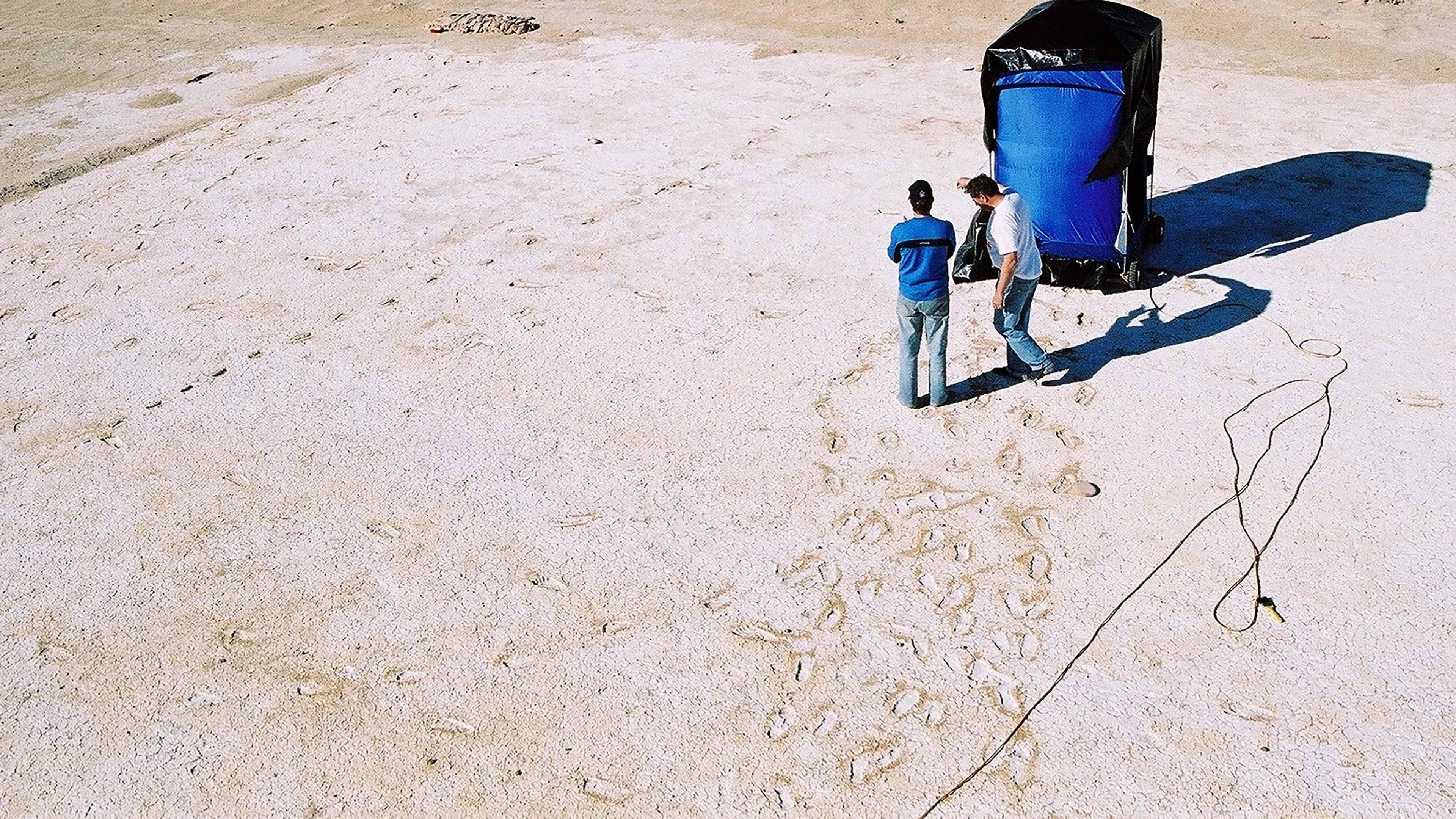 Prior to 3D scanning and LiDAR there was photogrammetry. The blue tent is on wheels and contains a camera array to capture 3D photogrammetry of each individual footprint. In 2005, it took 45 mins per print. Today it takes seconds to capture the hole site. (Image from NPWS) 