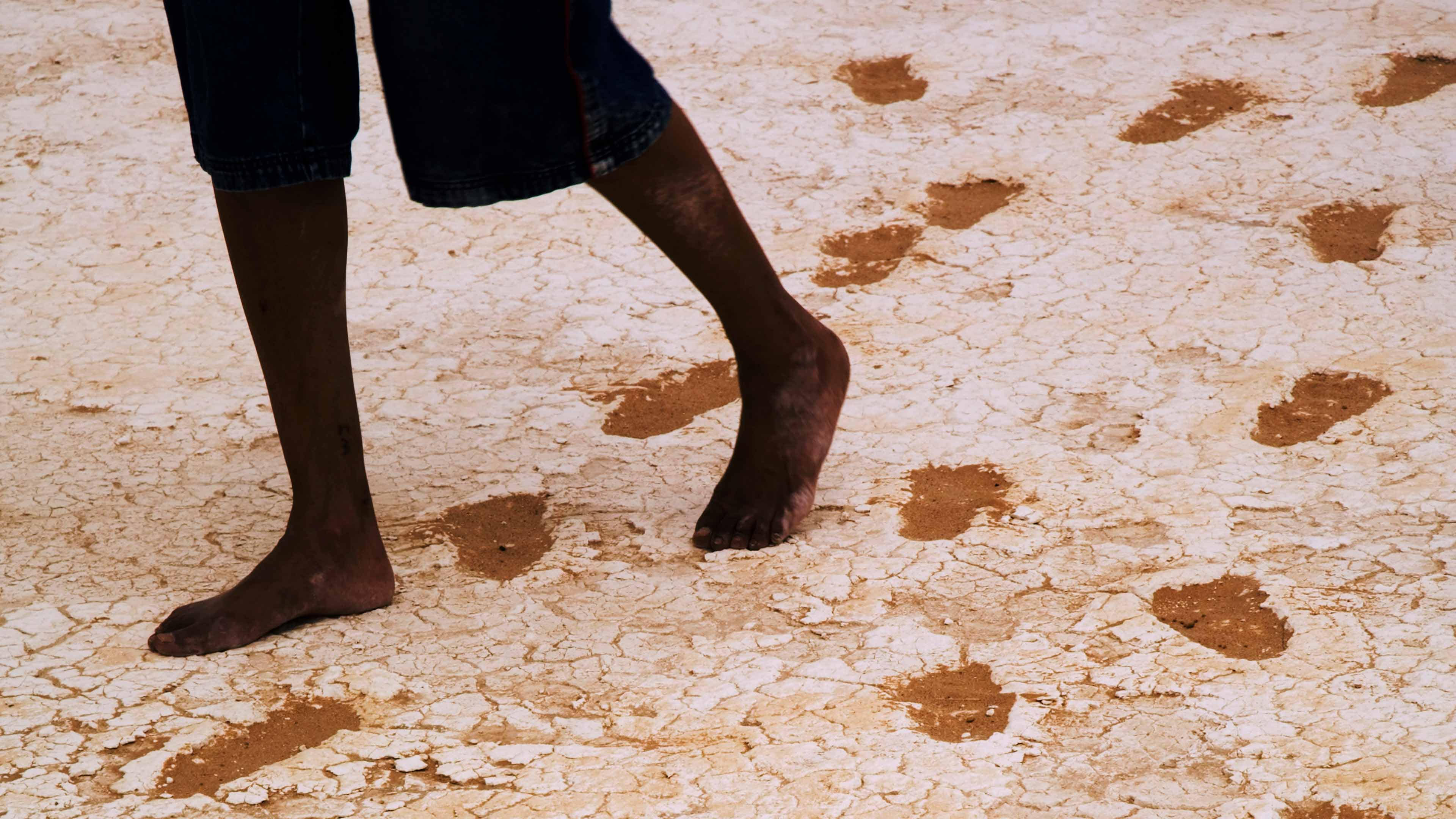 Walking with the Ancestors, community member inspecting the site prior to reburial (Image Courtesy Michael Amendolia)
