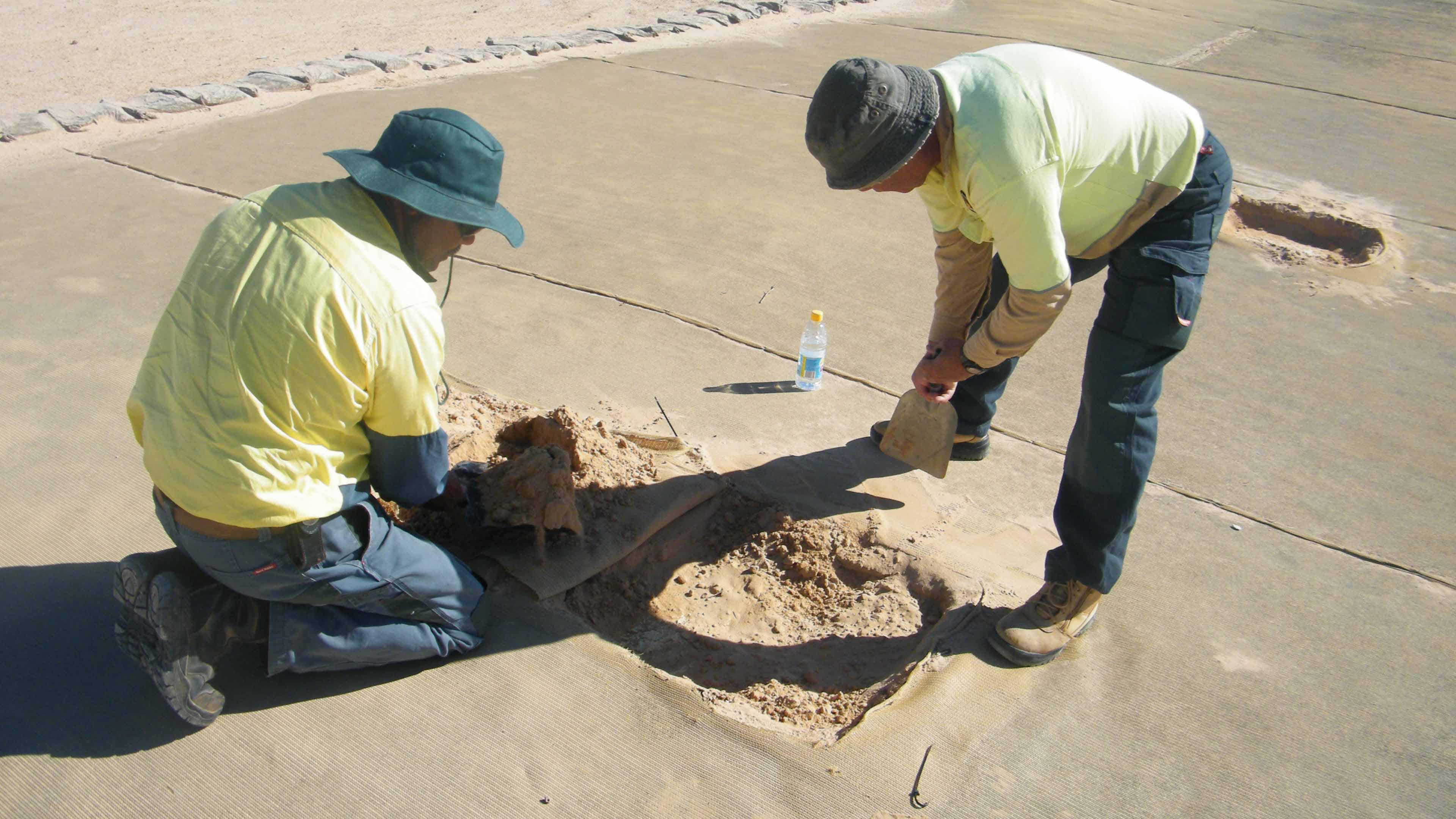 National Parks Aboriginal staff members carrying out conservation on shade cloth after monitoring of site. (Image from NPWS)