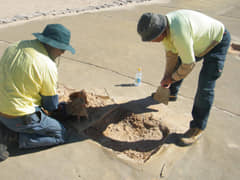 National Parks Aboriginal staff members carrying out conservation on shade cloth after monitoring of site. (Image from NPWS)